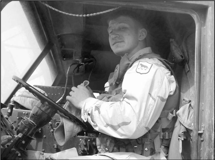 Courtesy Photos Justin Schlecht poses for a photo at the wheel of his Heavy Expanded Mobility Tactical Truck (HEMTT) in Iraq.  